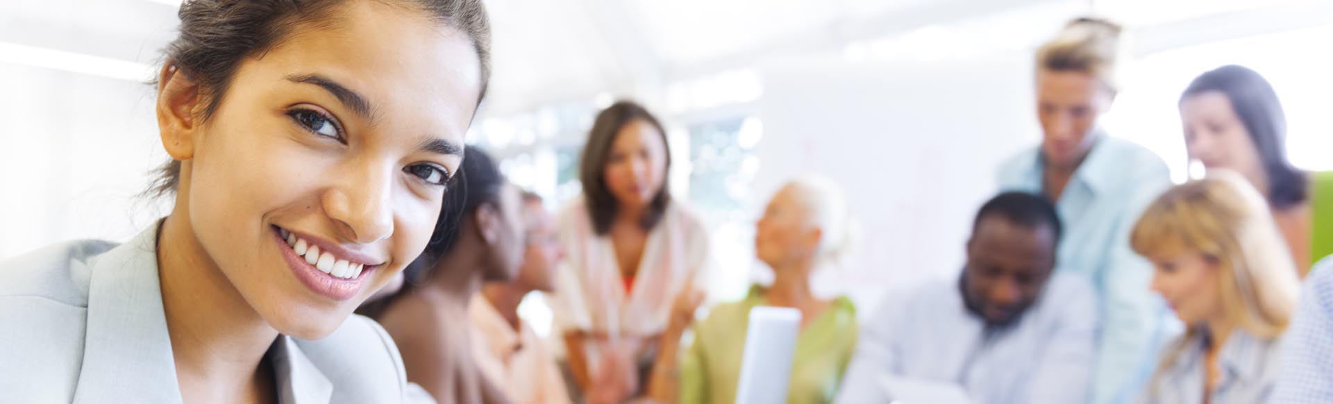 young business woman posing with business group behind