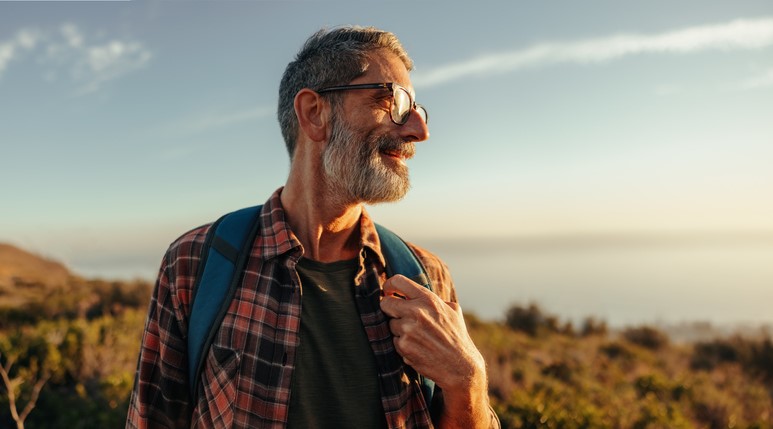 Medicare aged man hiking in Michigan