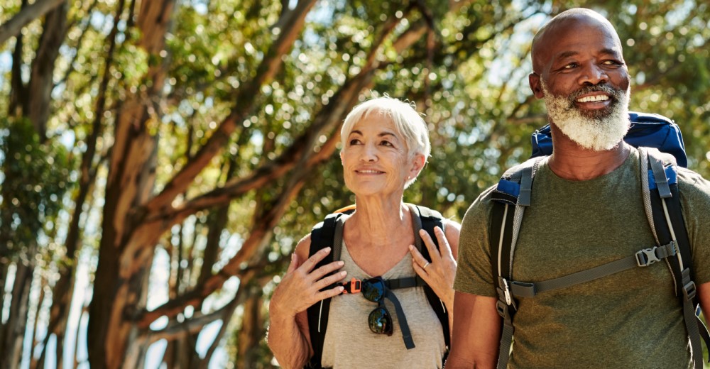 Medicare aged man and woman hiking in Michigan