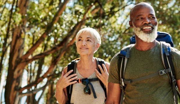 Medicare aged man and woman hiking in Michigan